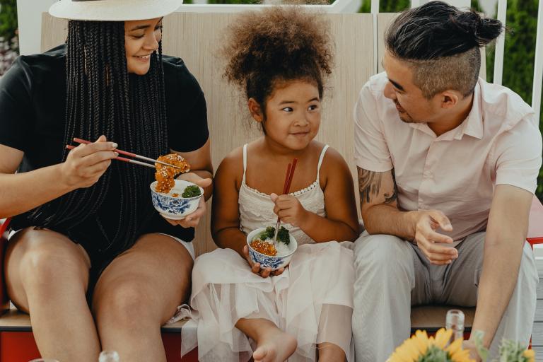 Family sitting down to eat.