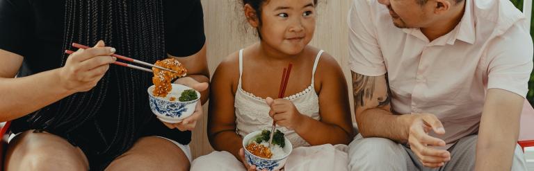 Family sitting down to eat.